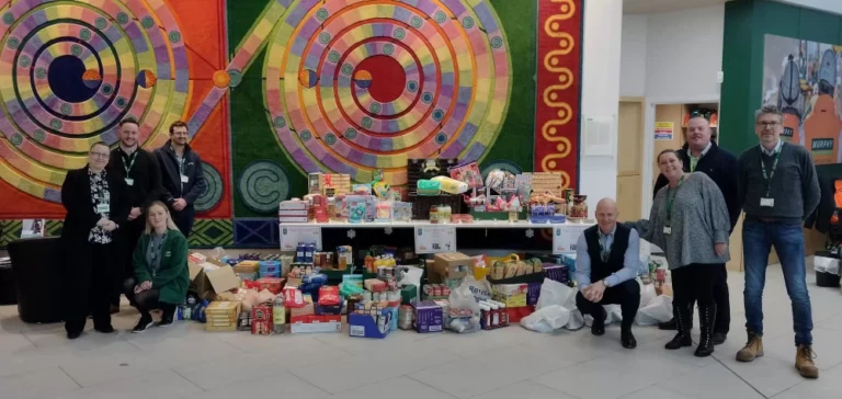 Several Murphy colleagues stood beside an assortment of donated food items.