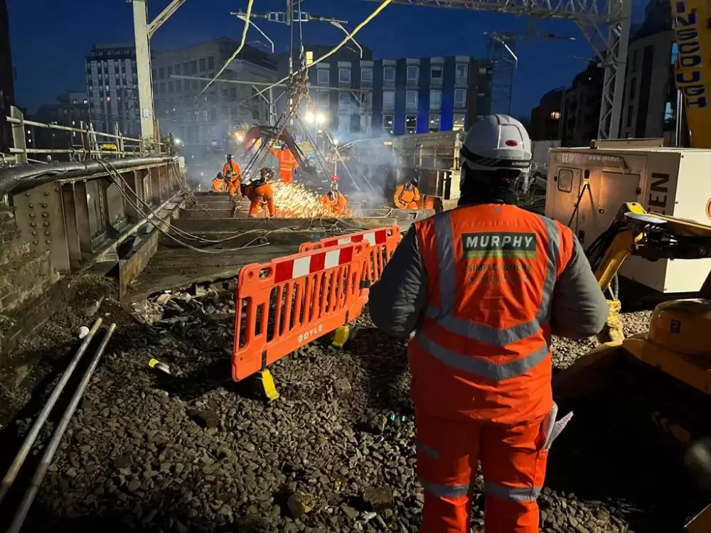 Murphy employees working on a railway bridge construction site in the evening