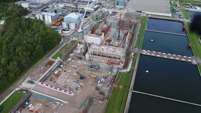 An aerial view of a clean back wash tank construction site surrounded by trees.