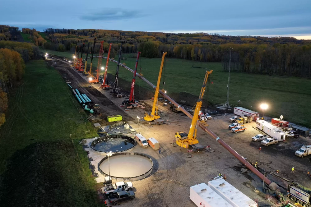 An aerial view of a construction site surrounded by fields and trees in Canada.
