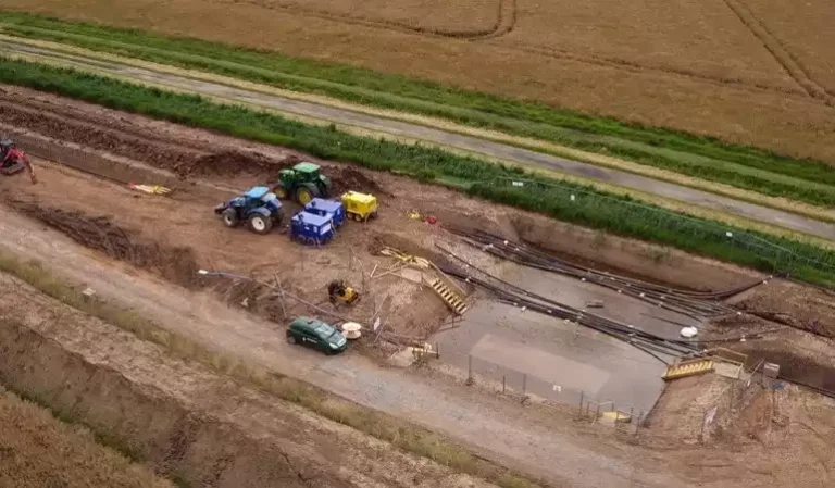 An aerial view of a cable installation site surrounded by fields.