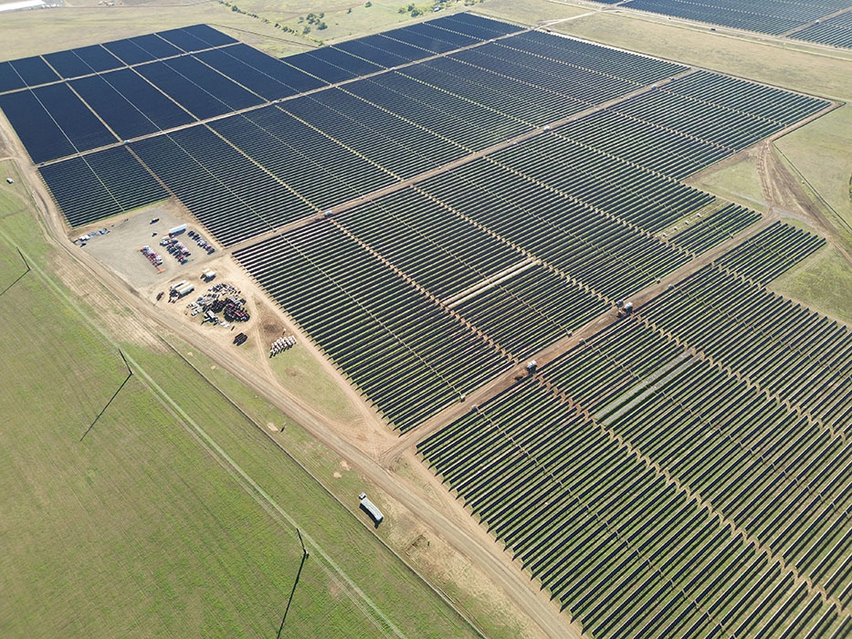 An aerial view of a solar farm surrounded by fields.