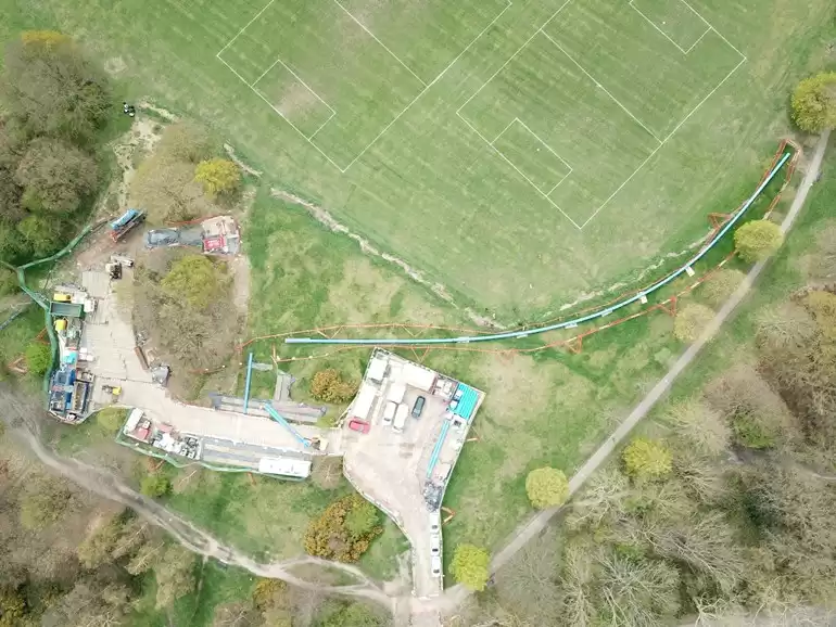 A birds eye view of a Thames water network site surrounded by fields and trees.