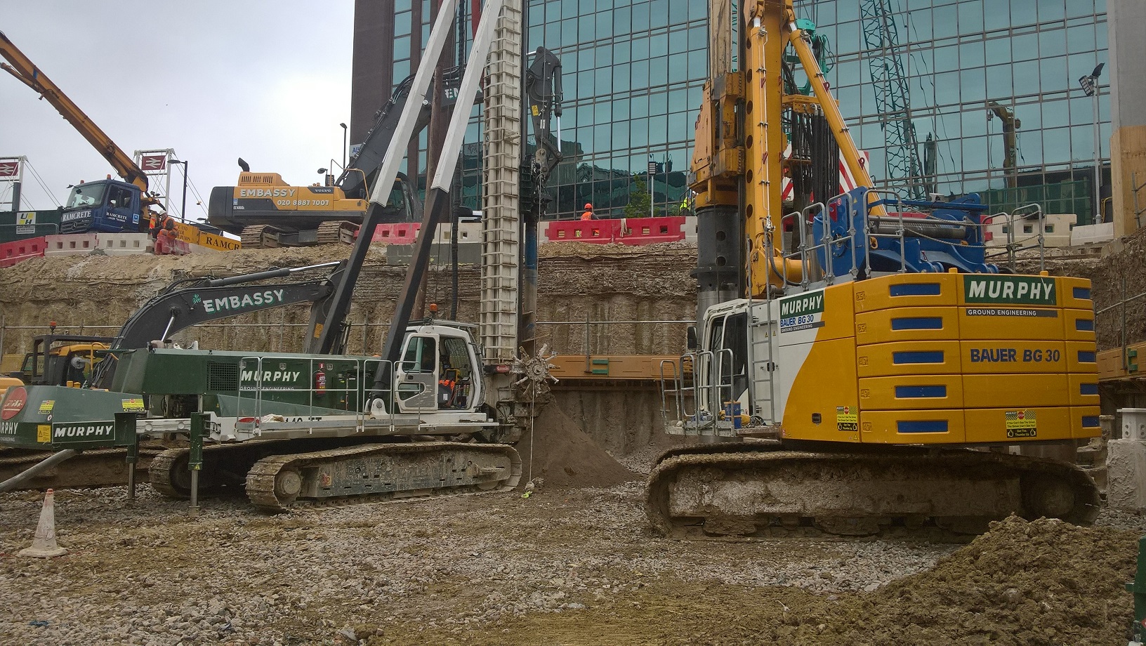 Several construction vehicles at an excavation site in Croydon.