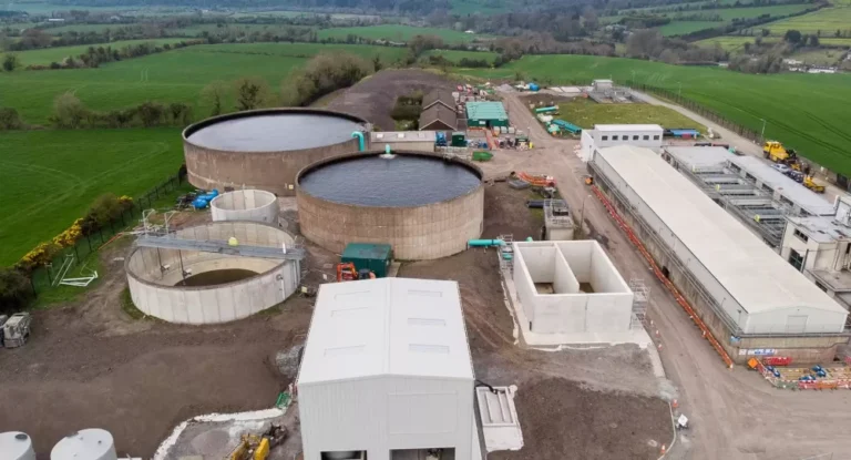 A water treatment plant surrounded by trees and fields.