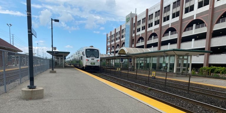 A train pulling into a station platform at Oakville Station Canada.