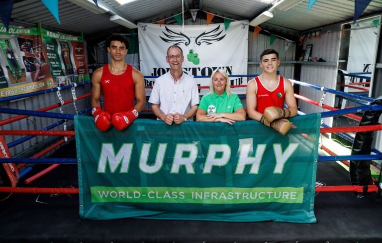 Four people stood in a boxing ring at Jobstown boxing club.