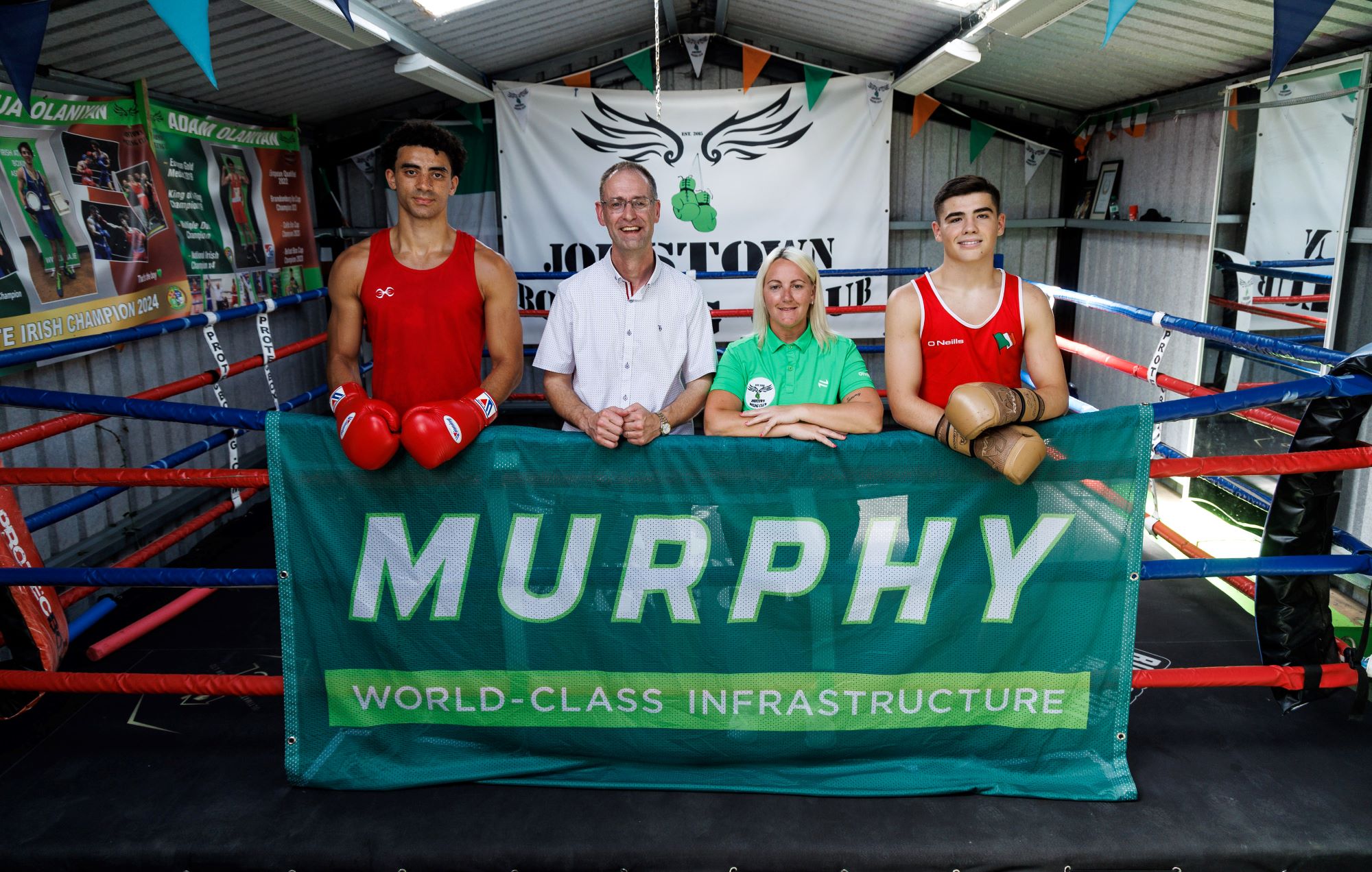 Four people stood in a boxing ring at Jobstown boxing club.