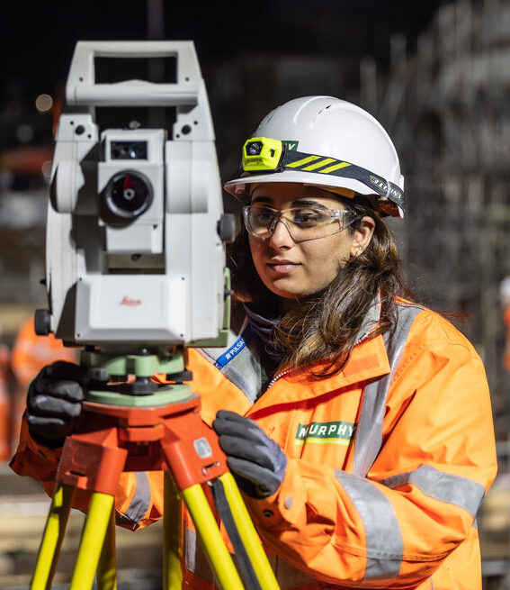 A Murphy colleague using a tripod-mounted measuring device.