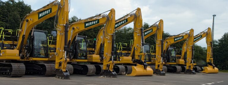 Yellow construction vehicles with the Murphy logo parked in a row.