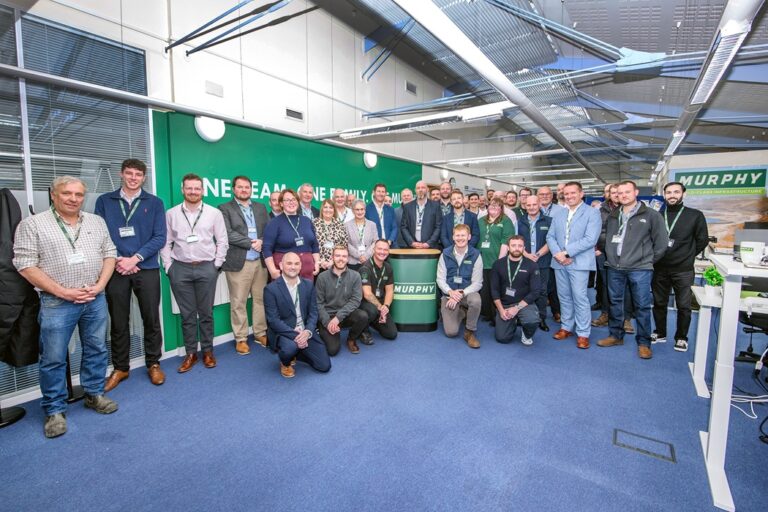 A large group of Murphy employees posing for a photo at the new Scotland office.