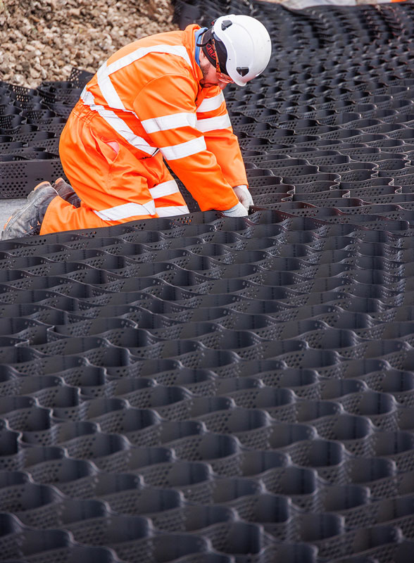 A Murphy employee in high-visibility uniform, a white helmet and safety goggles working on a construction site